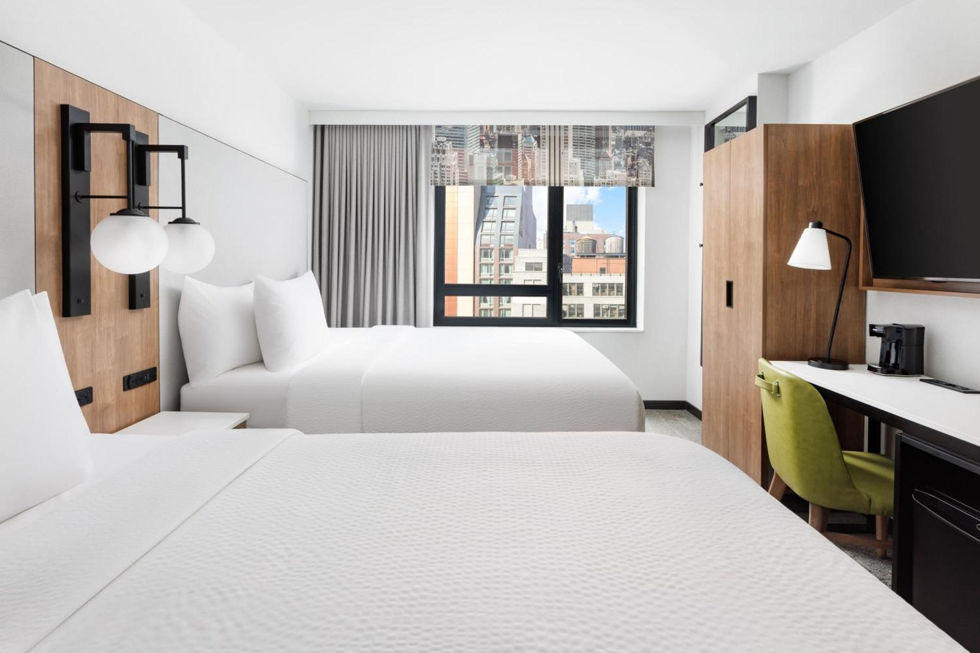 Habitación con 2 camas grandes y vistas a la ciudad