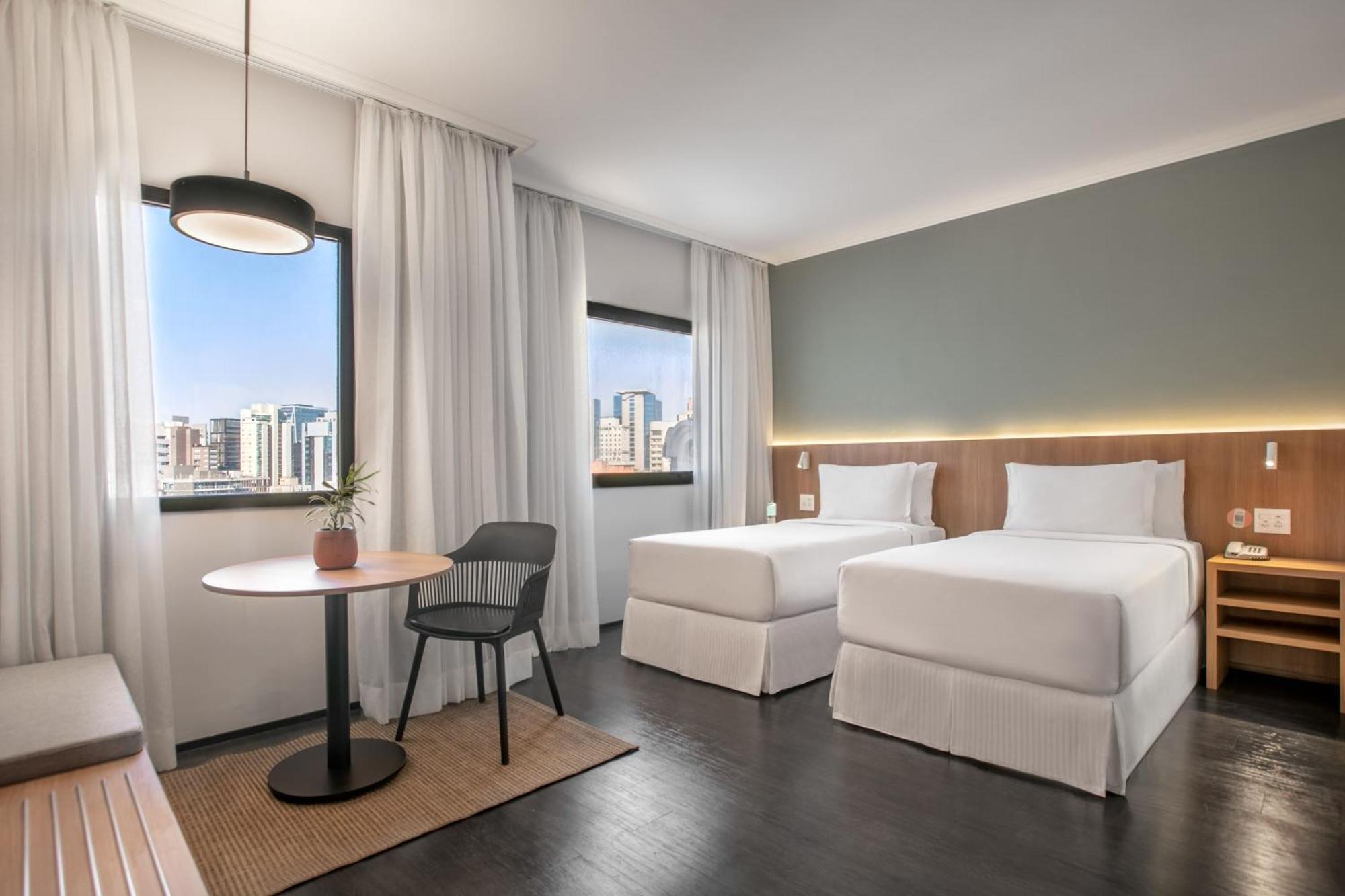 Quarto Innside com 2 camas de solteiro e vista da cidade
